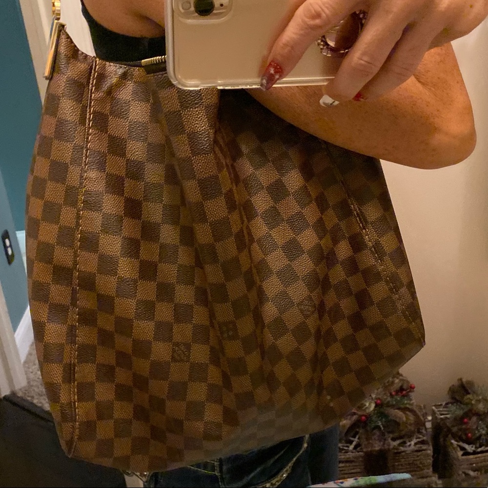 Woman’s Louis Vuitton purse